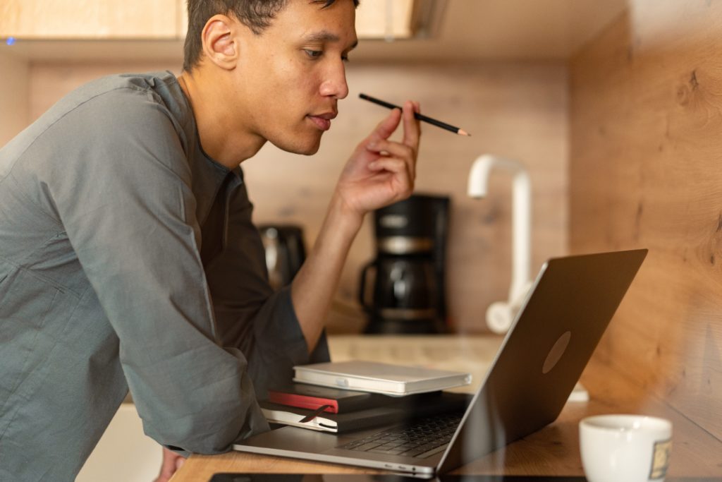 Man looking at computer hosting options